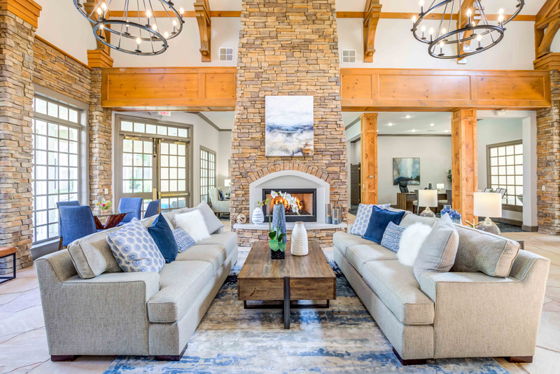 a large living room with couches and a fireplace