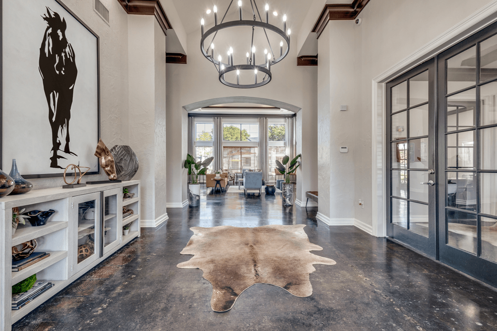 a hallway with glass doors and a rug on the floor