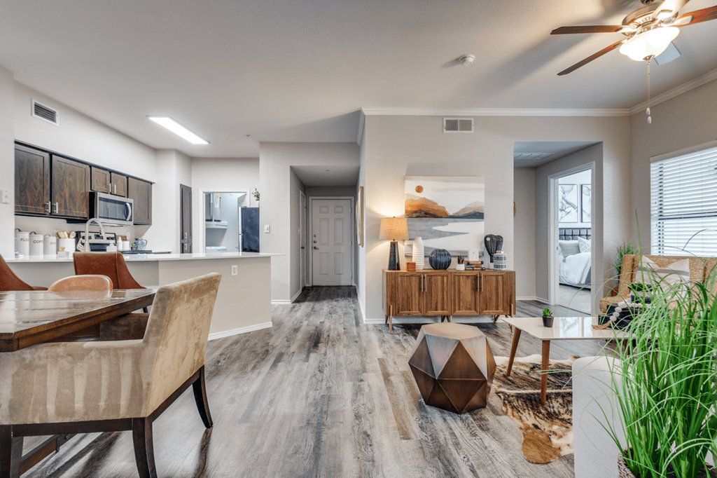the living room and kitchen of a manufactured home with a dining room table and chairs