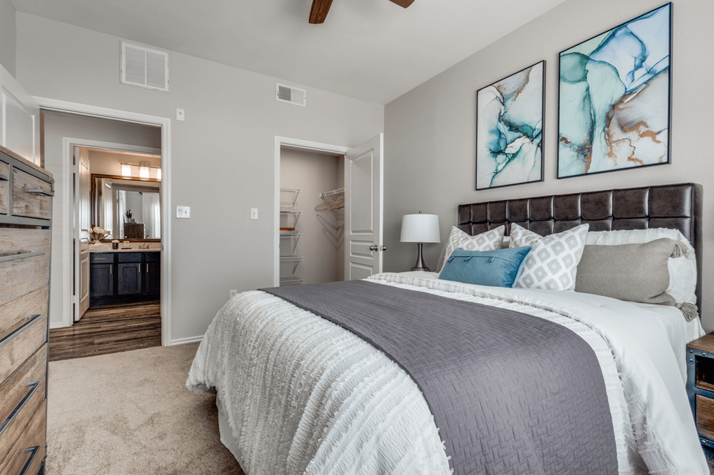 a bedroom with a large bed and a bathroom