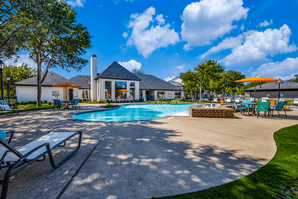 our apartments have a large swimming pool with chairs and umbrellas