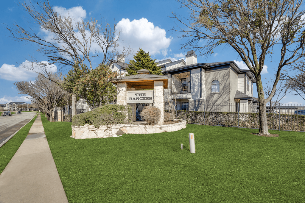 a large house with a sidewalk in front of it