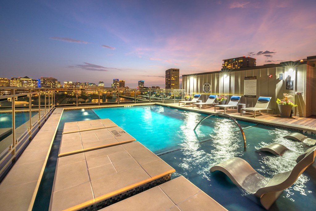 Rooftop pool facing downtown Dallas at night