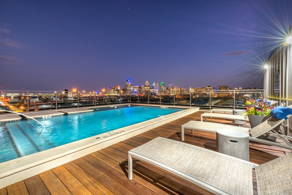 Rooftop pool facing downtown Dallas at night