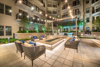 Outside seating area surrounding water fixture and decorative outdoor lighting - Photo Gallery 10