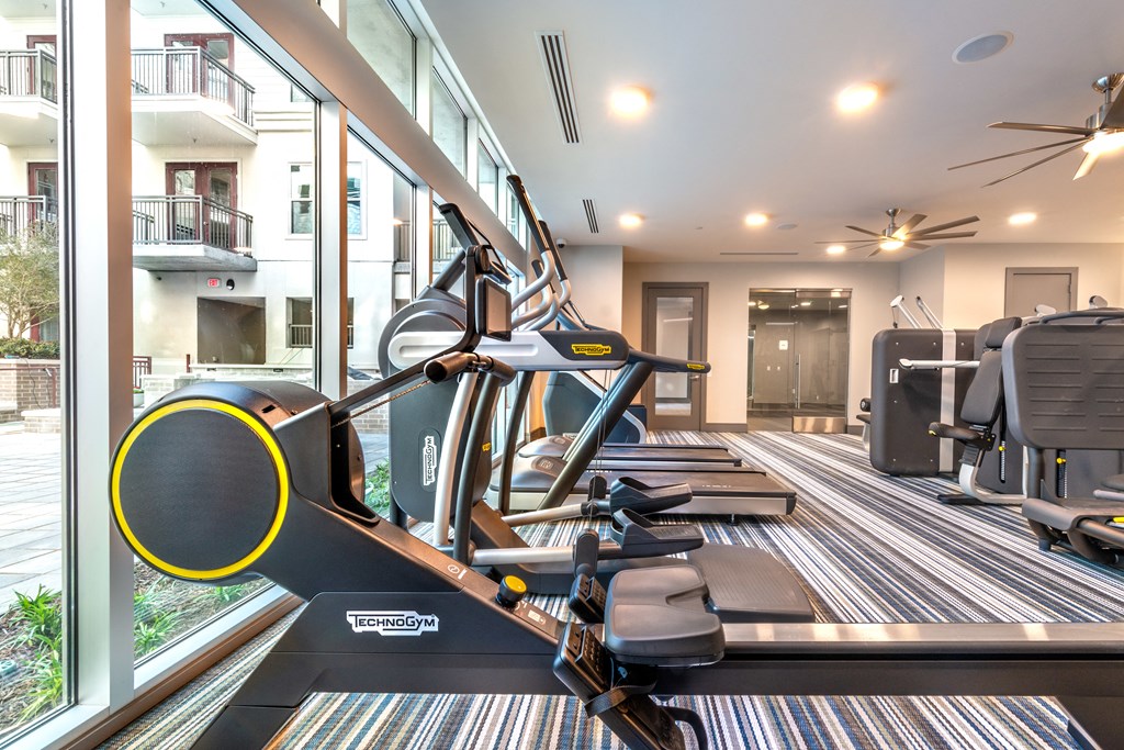 Fitness center area facing a stair climber and exterior windows