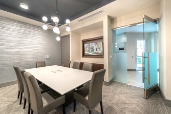 Conference area facing two glass doors and a decorative light fixture. - Photo Gallery 29
