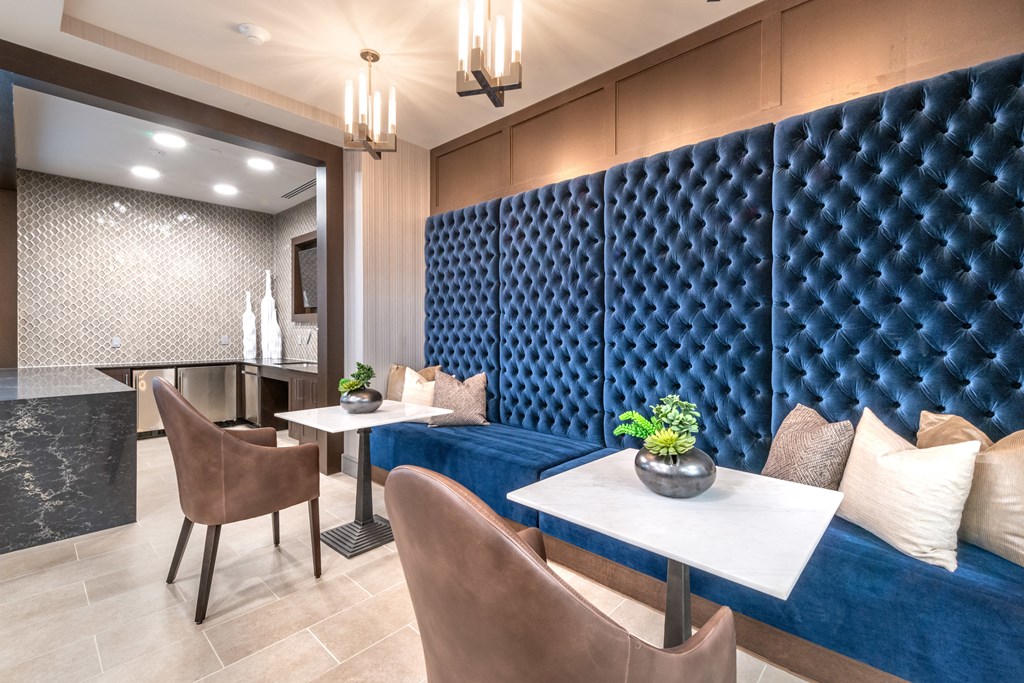 Resident common area facing two booth seats and decorative lighting