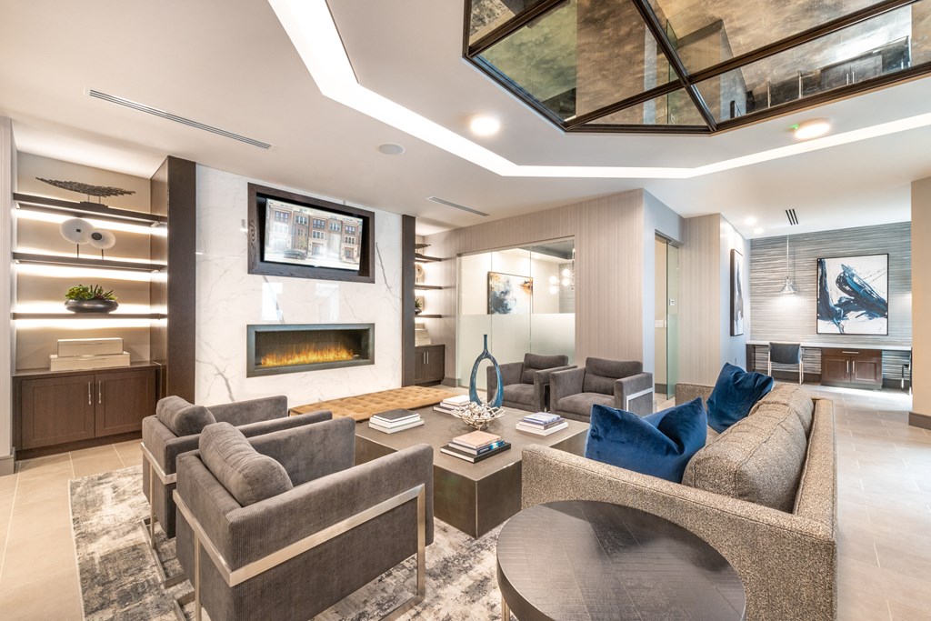 Interior of resident clubhouse facing common area with chairs and a table