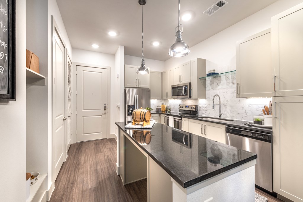 Kitchen area facing entry doorway and island area.
