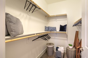 Interior of closet area with pillows and hangers stored on the shelf - Photo Gallery 130