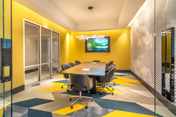 Private conference room with long table, chairs and wall mounted television - Photo Gallery 27