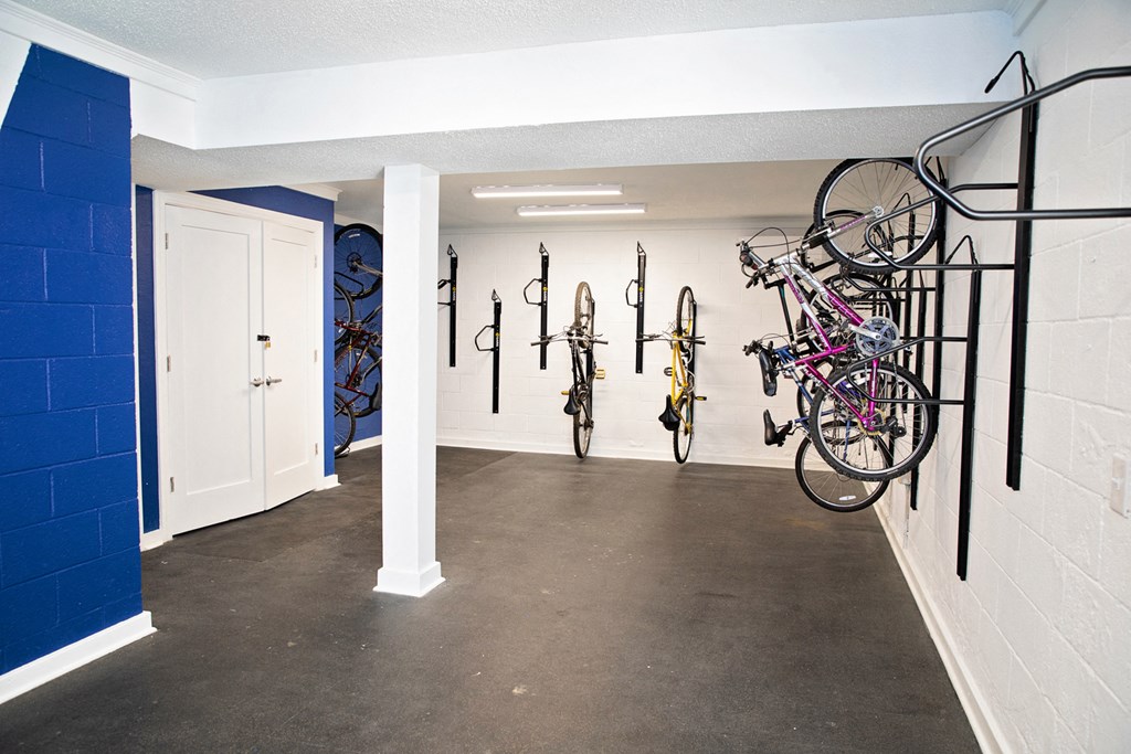 A bike storage room with bikes hanging on the wall.
