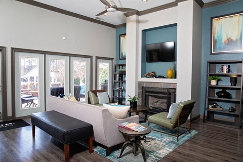 A living room with a fireplace, a chair, a sofa, and a coffee table.