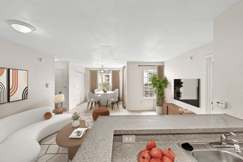 A modern kitchen with a dining table and chairs in the background.