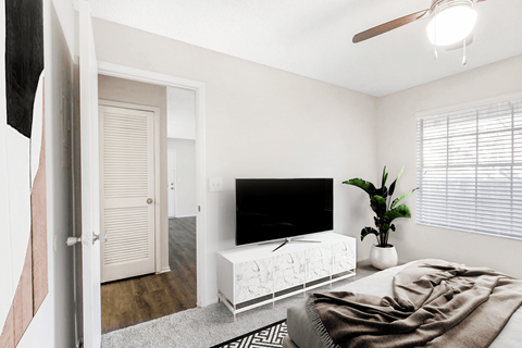 A modern bedroom with a large bed and a flat screen TV.