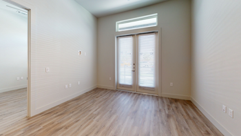 Livingroom with wood style flooring and door with blinds - Photo Gallery 58