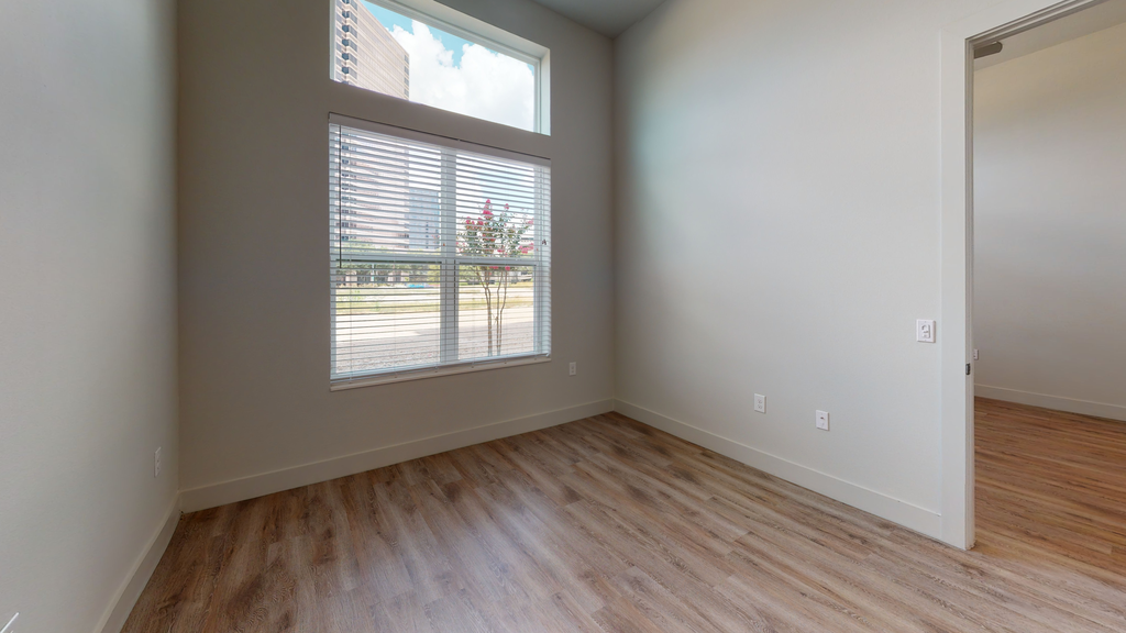Livingroom with wood style flooring, large windows with blinds