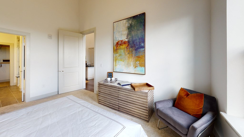 Bedroom facing dresser and large painting