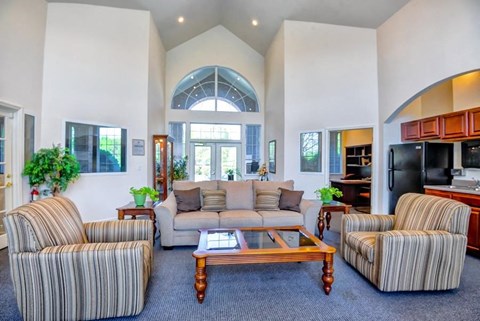 A living room with striped chairs and a wooden coffee table.