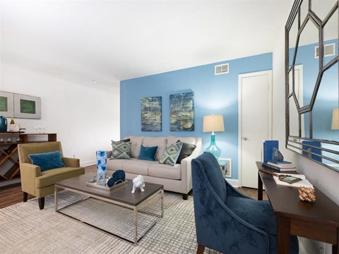 Furnished Model Living Room with Couch Armchair Coffee Table and Desk
