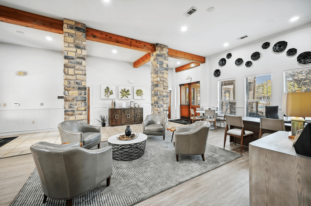 a living room with couches and chairs and a fireplace