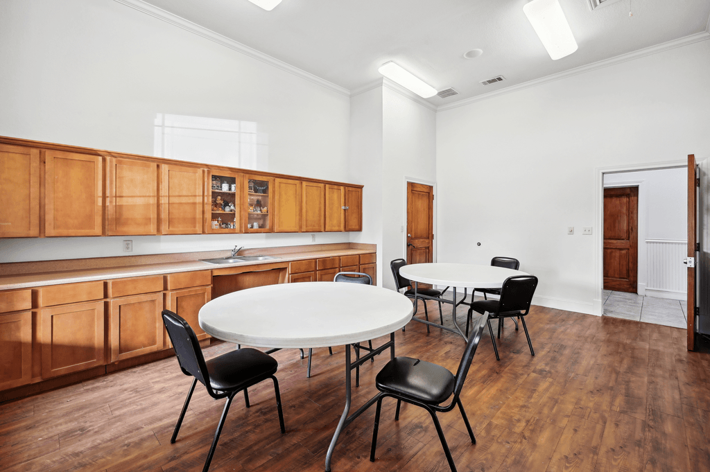 a dining room with a table and chairs and a kitchen