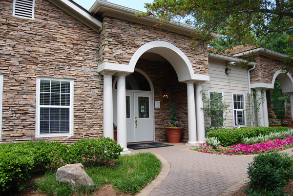 the arched entryway of a brick house with a white door