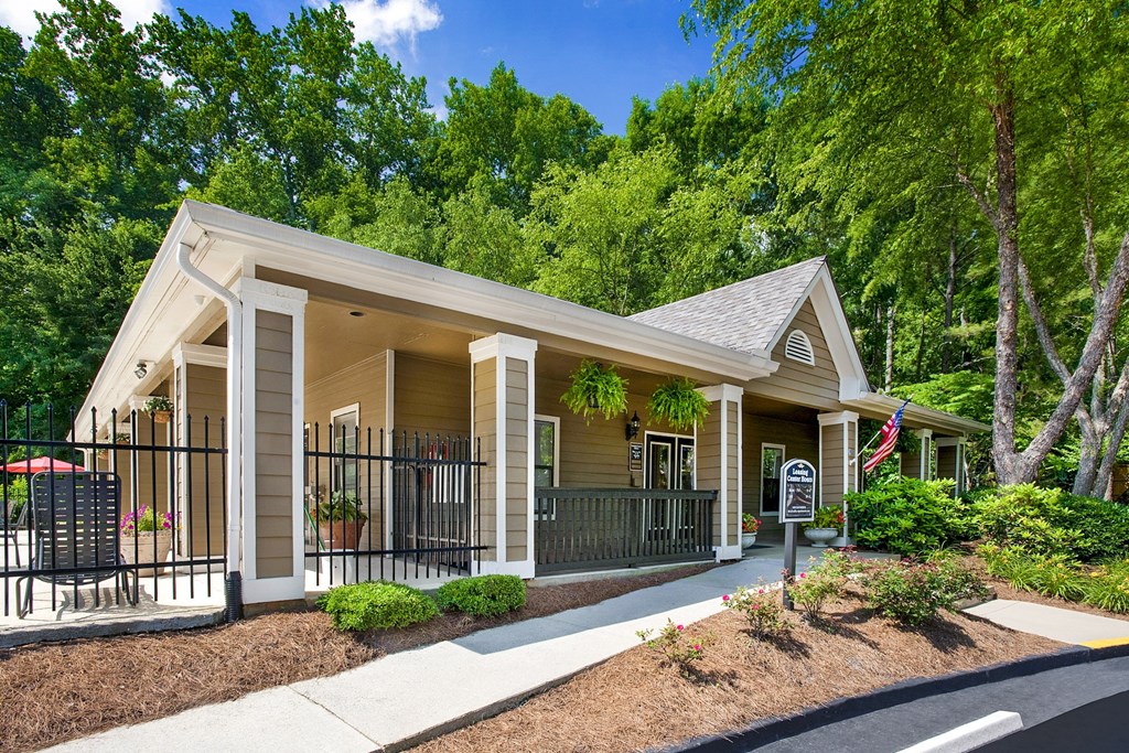 A small house with a porch and a flag on it.