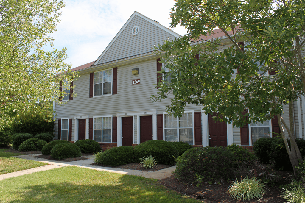 exterior apartment building with red front doors and shutters