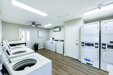 A laundry room with washers and dryers.