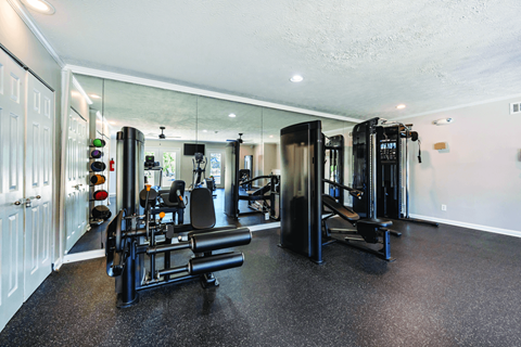 A spacious home gym with a variety of equipment.