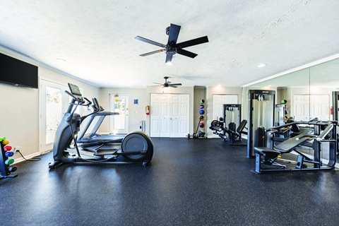 A spacious home gym with a variety of exercise equipment.