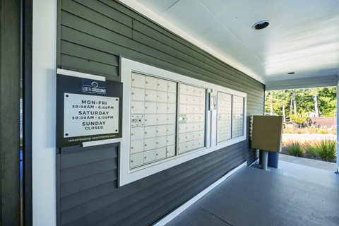 A sign on a wall indicating the hours of operation for Lee's Orchard.