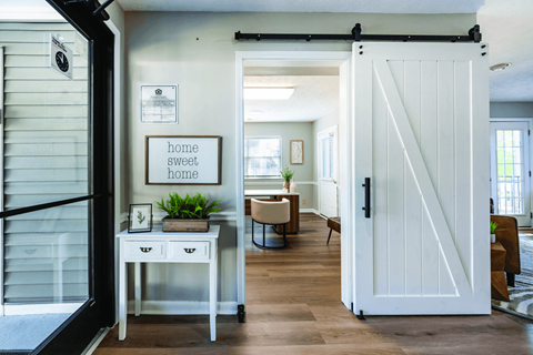 A white door with a black handle is open.