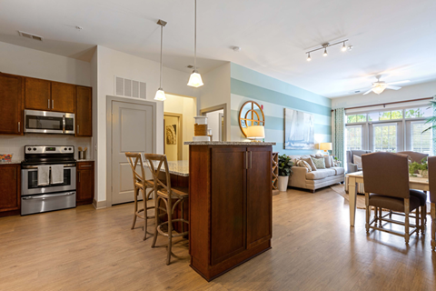 A kitchen with wooden cabinets and a large island.