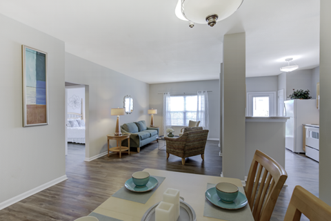 A dining room with a table set for two.
