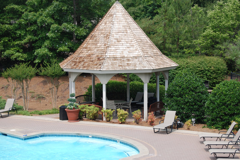 a gazebo next to a swimming pool