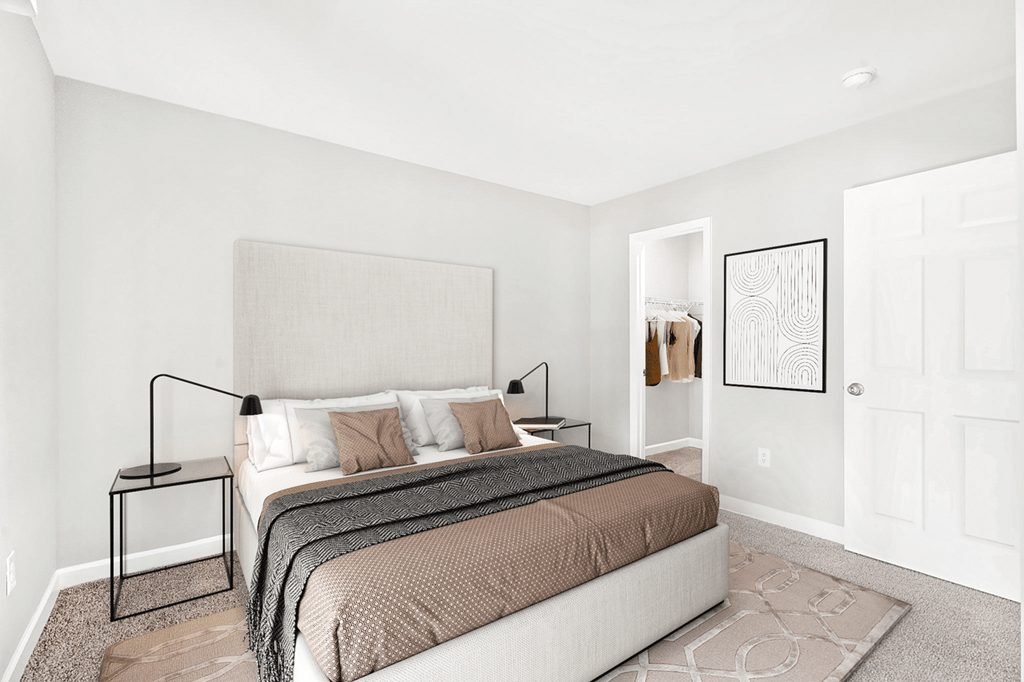 A bedroom with a bed, nightstand, and a framed picture on the wall at Paces Pointe Apartment Homes, Matthews, 28105