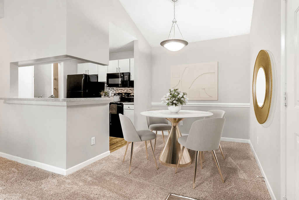 A modern kitchen with a dining table and chairs at Paces Pointe Apartment Homes, Matthews, North Carolina