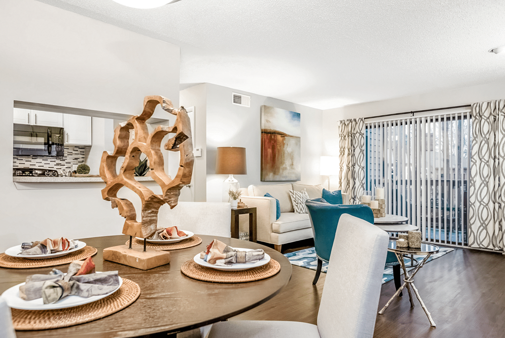A modern dining room with a wooden table and chairs at Paces Pointe Apartment Homes, Matthews, North Carolina