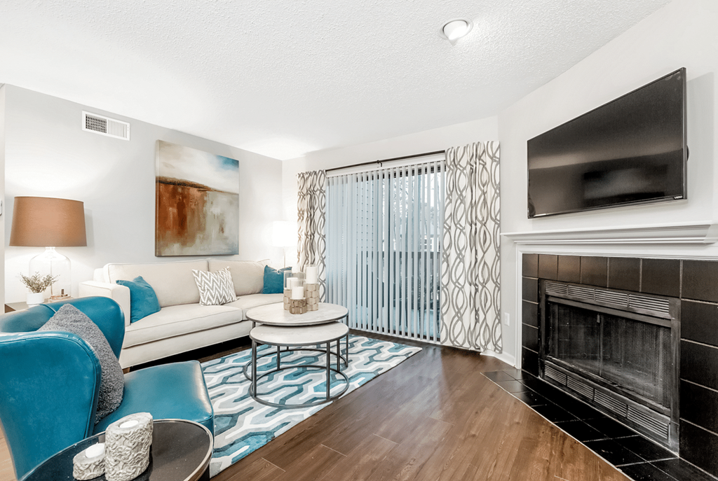 A living room with a fireplace and a television at Paces Pointe Apartment Homes, Matthews, NC, 28105
