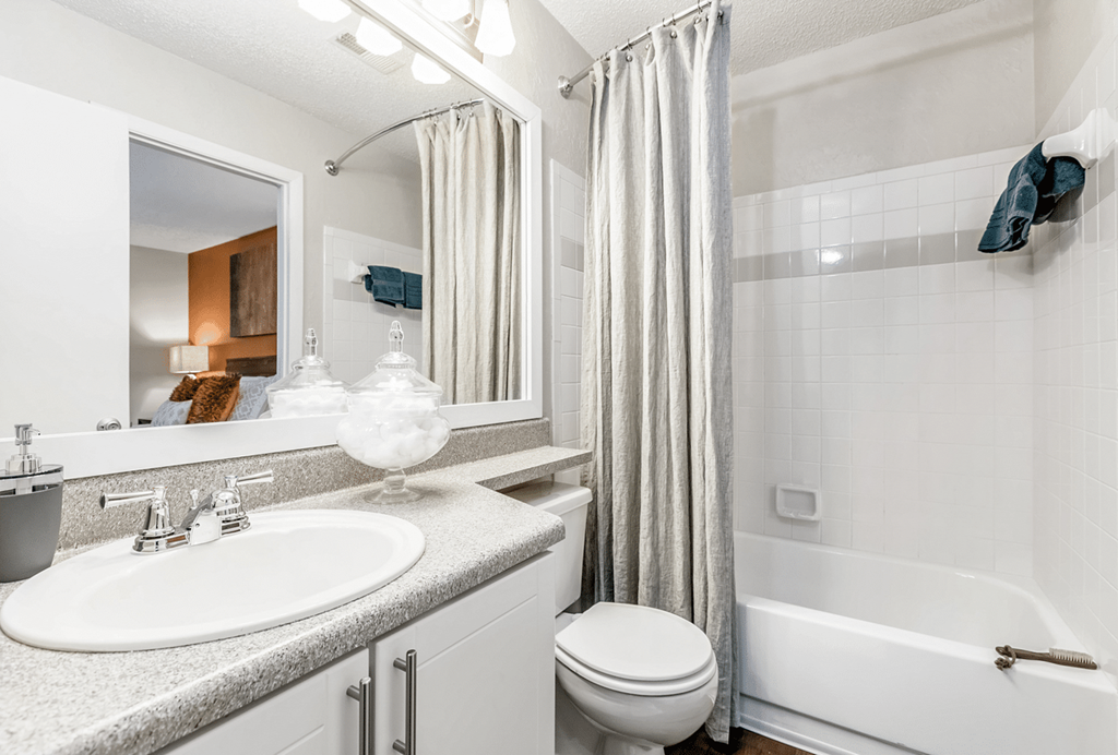 A white bathroom with a sink, toilet, and bathtub at Paces Pointe Apartment Homes, Matthews, NC, 28105