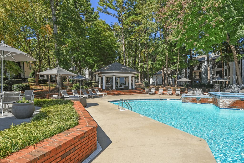 A pool area with a brick border and a gazebo at Paces Pointe Apartment Homes, North Carolina, 28105