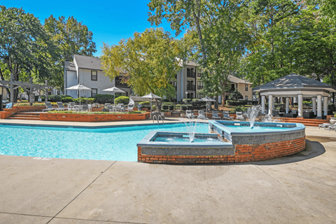A pool with a fountain in the middle of it.