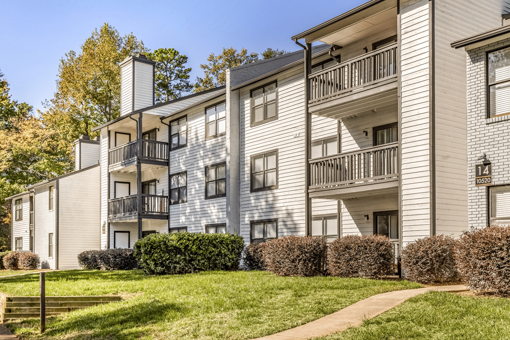 Apartment building with a balcony on the second floor at Paces Pointe Apartment Homes, Matthews, North Carolina