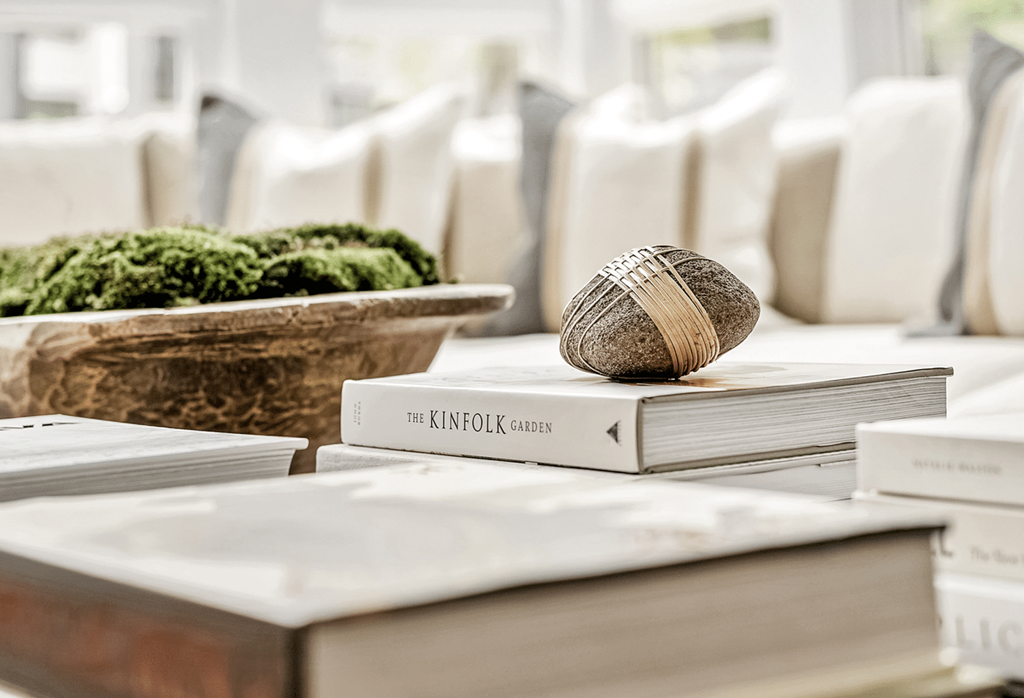 A book with a striped cover is on top of a stack of other books at Paces Pointe Apartment Homes, Matthews, NC, 28105