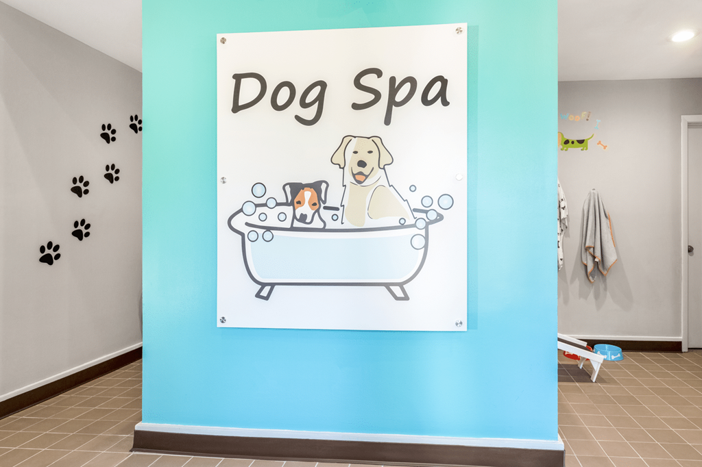 A sign that says Dog Spa with a drawing of a dog in a bathtub at Paces Pointe Apartment Homes, North Carolina, 28105