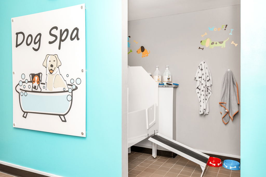 A dog spa sign is on the wall above a bathtub at Paces Pointe Apartment Homes, Matthews, NC