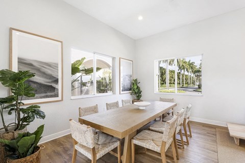 a dining room with a wooden table and chairs